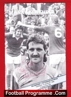 Black-and-white football programme cover with a portrait of a player in the foreground, a cheering crowd behind, signed autographs, and 'Football Programme .Com' at the bottom.