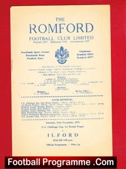 Front cover of a vintage Romford Football Club programme on a red surface, showing the club name and crest at top.