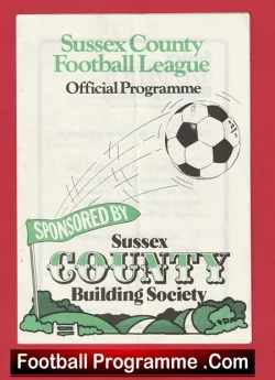 Cover of the Sussex County Football League official programme, featuring a moving soccer ball, sponsor banner for Sussex County Building Society, and football-themed artwork on a decorative hillside background, with 'Football Programme.com' at the bottom.