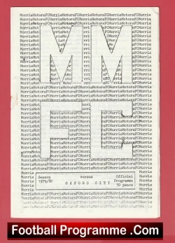 Front cover of a football programme with a pink border, featuring large stylized 'M' shapes and the site text 'FootballProgramme.com' at the bottom.