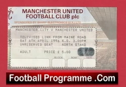 Close-up of a red-bordered Manchester United football match ticket stub, with sponsor text and seating details, and a bottom banner reading 'Football Programme.Com'