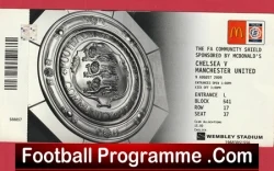 Close-up of a football programme cover featuring a crest with a ticket stub on the right and a red footer banner reading Football Programme.com.