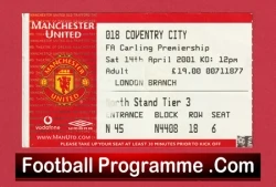Red Manchester United matchday programme cover with club crest and the text 'Football Programme .Com' at the bottom.