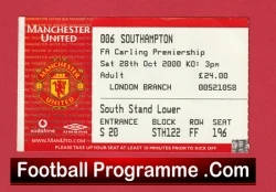 Red Manchester United ticket stub with club crest, seating 'South Stand Lower' and price details; FootballProgramme.com watermark.