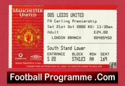 Front cover of a Manchester United vs Leeds United football programme, showing match details and a red bottom banner that reads FootballProgramme.Com