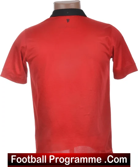 Red football jersey on a mannequin viewed from the back, with a black collar; watermark 'Football Programme.com' across the bottom.