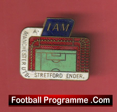 Enamel pin featuring a stadium diagram with a blue 'I AM' card, Manchester United labels (Stretford End) and a 'Football Programme .Com' banner.