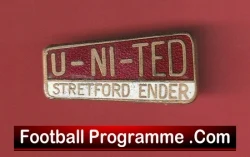 Close-up of a red wall with a white badge reading UNITED and a small 'Football Programme.com' label.