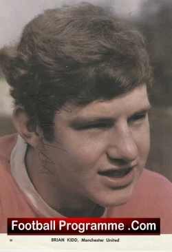 Close-up of a young footballer with brown hair in a red jersey, overlaid by a black banner reading 'Football Programme.Com' across the bottom.