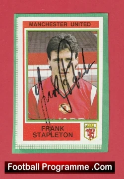 Manchester United football programme cover with a portrait of Frank Stapleton, signed in black across the photo, on a red background.
