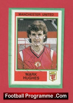 Autographed Manchester United football card featuring Mark Hughes in a red jersey, mounted on a red background.