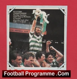 Footballers celebrate a trophy lift on a podium, with a 'Football Programme.Com' banner across the bottom.
