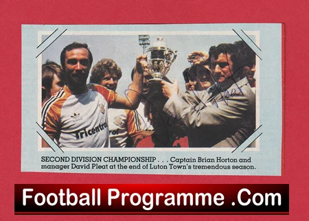 Football team celebrates winning the Second Division Championship, lifting a trophy, with players and staff nearby; caption mentions the season's end and a page titled 'Football Programme .Com'.