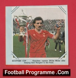 Aberdeen captain Willie Miller lifts the Scottish Cup trophy on the pitch after beating Rangers in the final (signed red jersey).