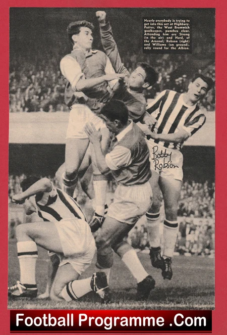 Black-and-white action photo of multiple soccer players leaping and colliding for the ball during a crowded match; a striped jersey player on the right and a banner reading 'Football Programme' appears along the bottom. A player’s shorts show the name 'Bobby Robson'.