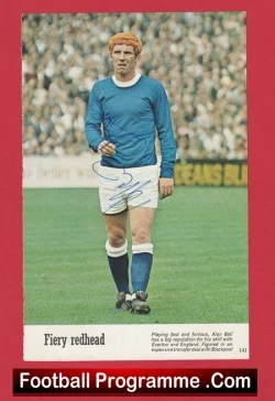 Football programme cover: red-haired footballer in a blue jersey and white shorts on a pitch, with 'Fiery redhead' caption and a 'Football Programme .Com' banner at the bottom.